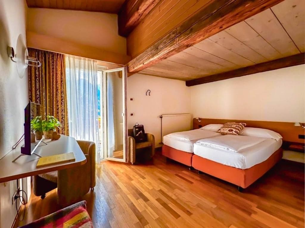 Pokój na poddaszu w hotelu Los Andes z belkowanym stropem, fotelami i wyjściem na balkon